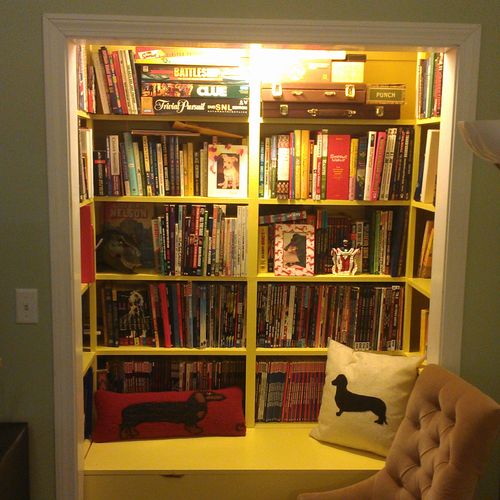 Custom bookshelf with bottom storage in a unused c
