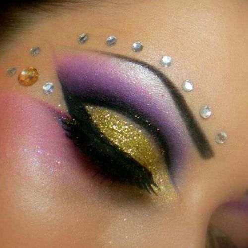Gold and purple make up look .