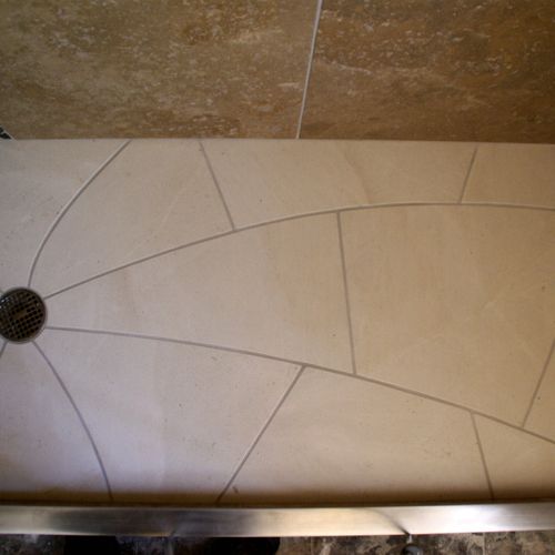limestone Shower pan w/ stainless threshold.