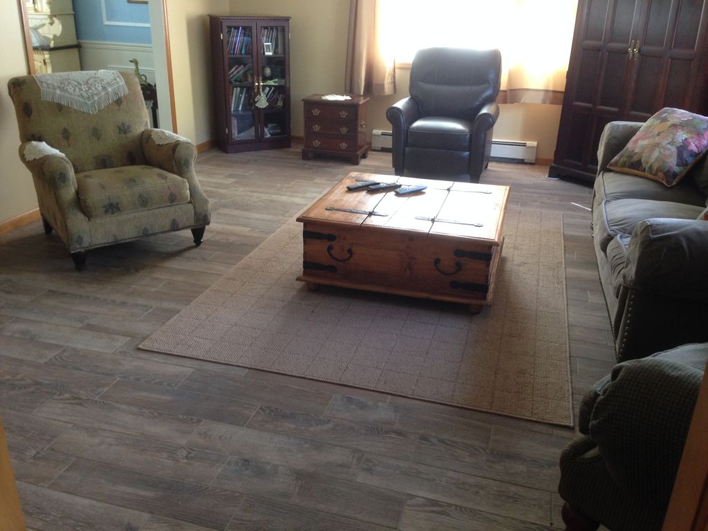 Beautiful, wood-look tile floor installed in Dinin