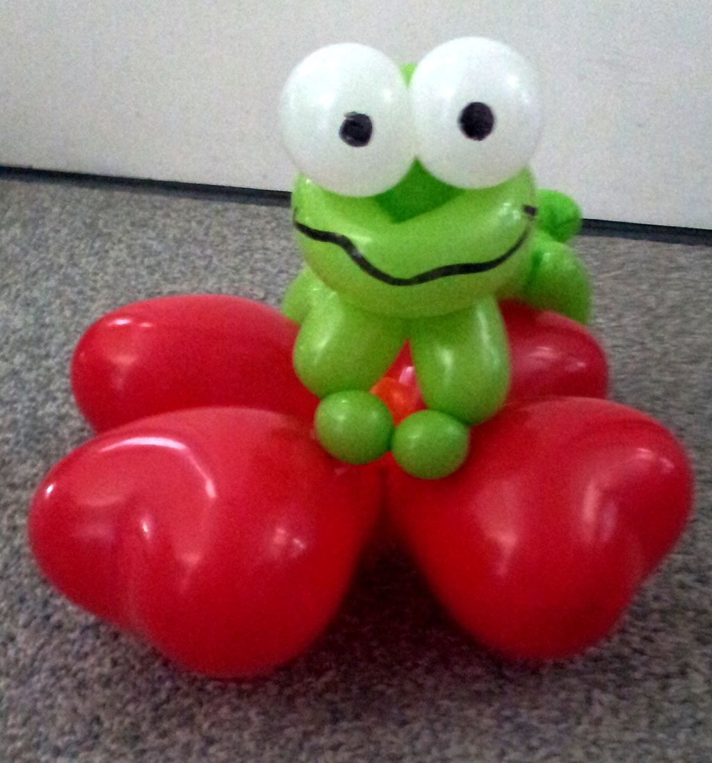 A fun frog on hearts.