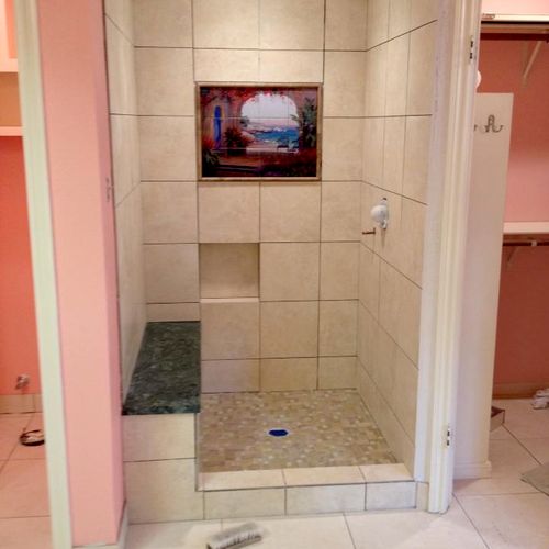 Newly installed tile shower with tile art centerpi