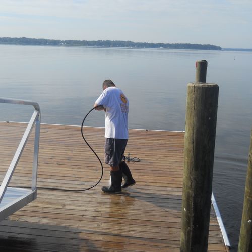 Pressure washing a dock preparing it for sealing a