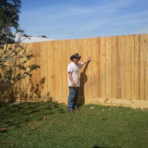 6' privacy fence with a 2" x 12" placed underneath