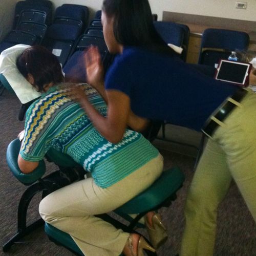 Chair massage on a teacher during "Teacher Appreci
