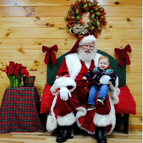 Santa on his bench with a handsome young man.