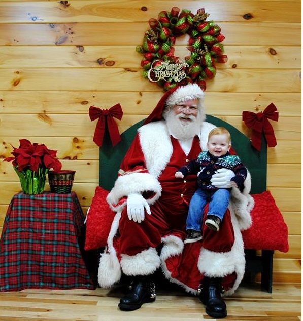Santa on his bench with a handsome young man.