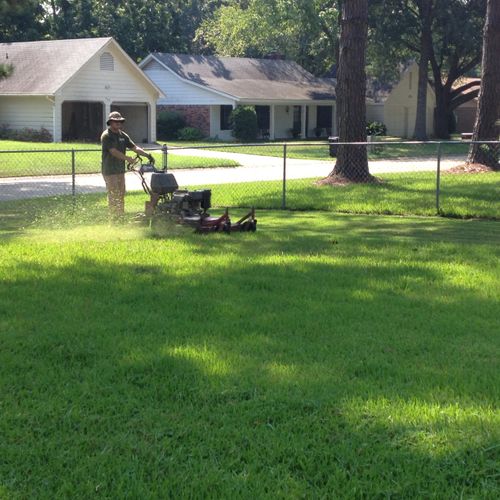 Performing lawn management services to property. (