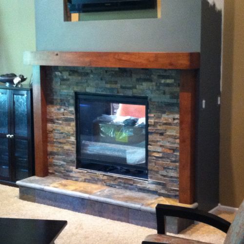 Fireplace with slate base, stack stone, and rustic