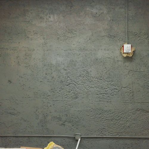 Porous cement wall with two coats. Two additional 