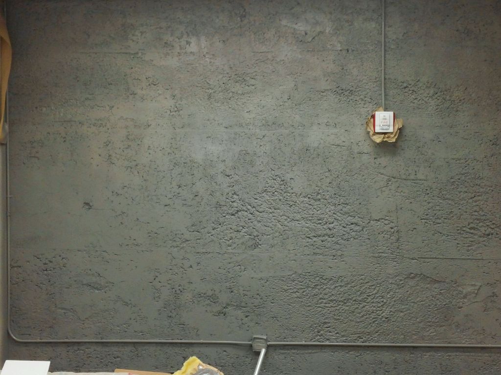Porous cement wall with two coats. Two additional 