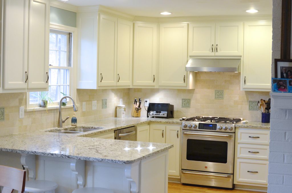 A beautiful white kitchen remodel with wood floors