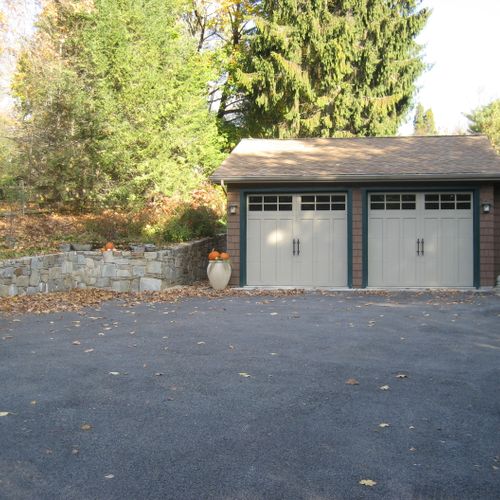Garage addition including retainer wall, area way,