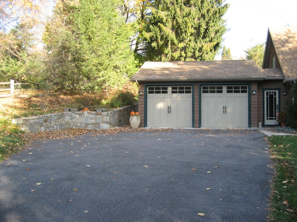 Garage addition including retainer wall, area way,