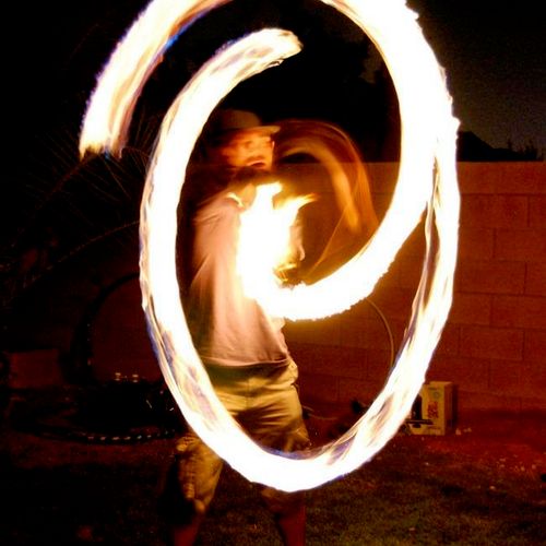 Fire spinning at a backyard party.