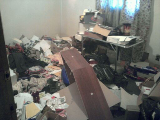 Before picture of one room in a "hoarder house we 
