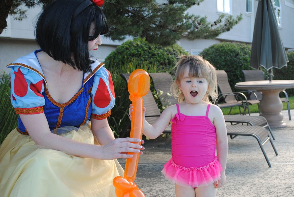 Snow White handing over a balloon giraffe to an ex