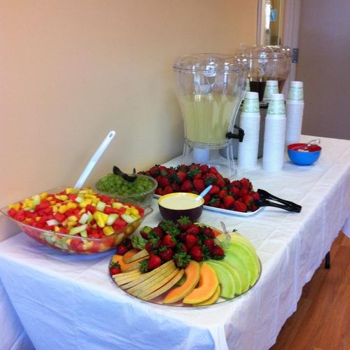 Fruit display, homemade yogurt dip, beverages.