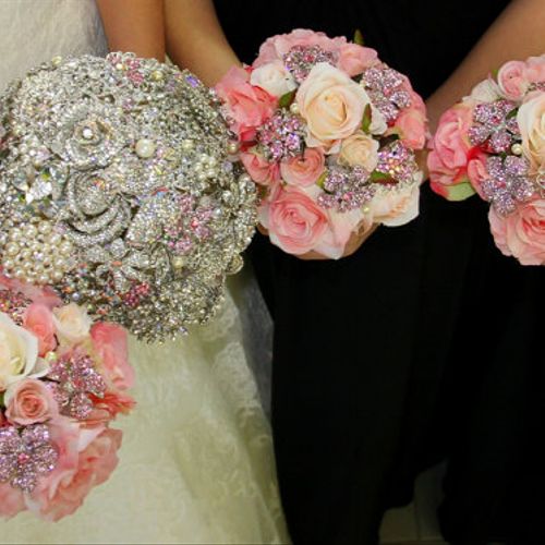 A silver and pink brooch bouquet, and silk and bro