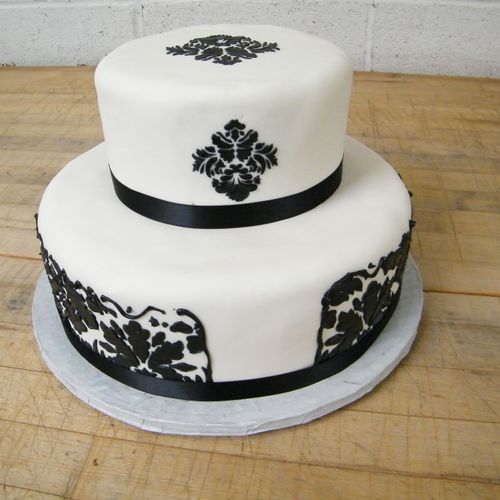 Fondant covered cake, stencil sides with ribbon ac