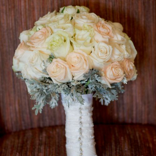 Hand tied bouquet of ivory, white and champagne ro