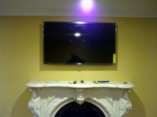 55" TV mounted over Fireplace with tilt mount