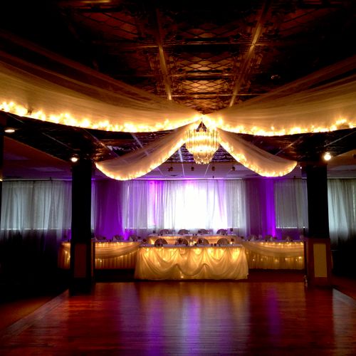 Head Table with purple up lighting and a ceiling s