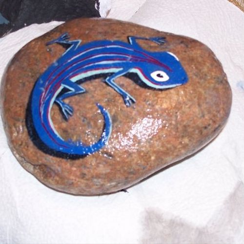 Painted lizard on a rock with acrylic paint.