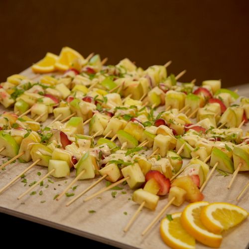 Fresh fruit kabobs served with gruyere cheese sauc