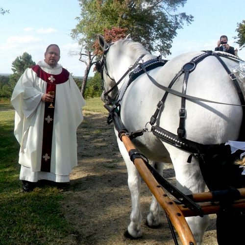 The priest blessing the horse!