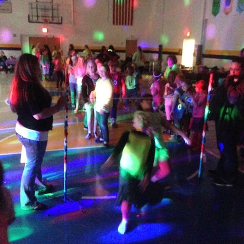 Girl Scouts dance the Limbo.