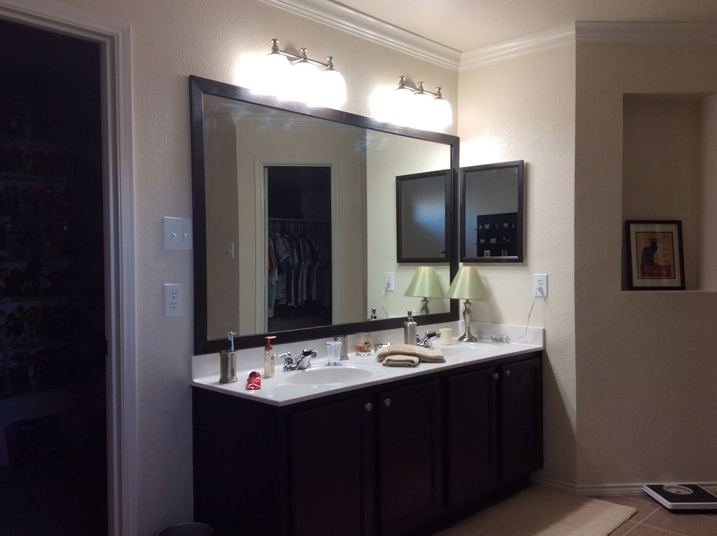 New sconces, framed mirror and stained vanity and 