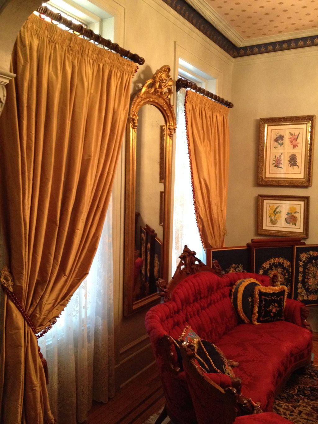 Large mirror hung on plaster wall.