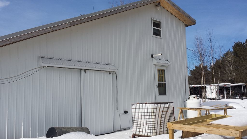Installed corrugated metal panel siding that broug