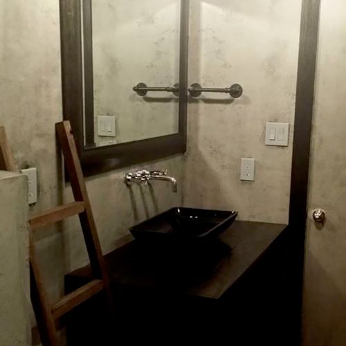 This was an industrial style bathroom with a custo