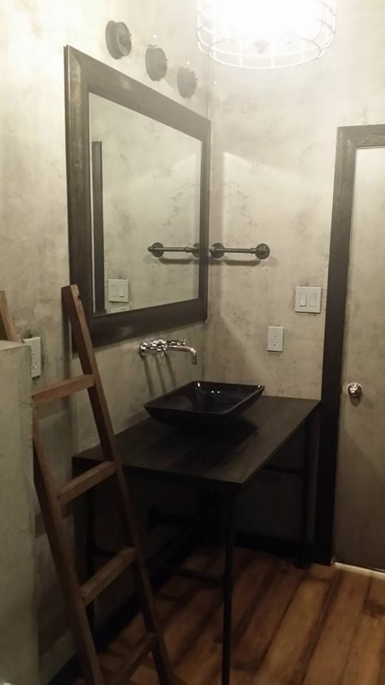 This was an industrial style bathroom with a custo