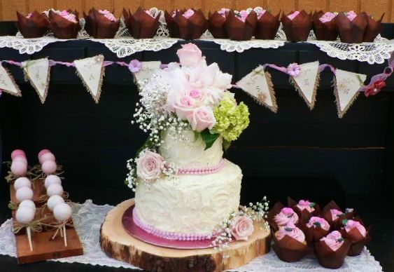 Two Tiered wedding cake adorned with fresh flowers