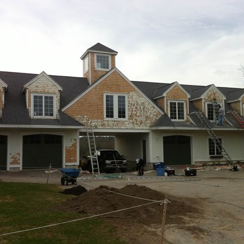 Stripping paint of shingle siding in Saco, Maine