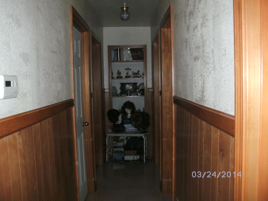 Dusting and cleaning hallway walls.