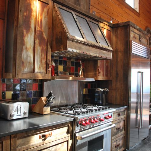 Log cabin high end kitchen with barn wood and leat