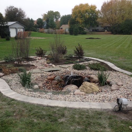 Pond install with bordering brick edging