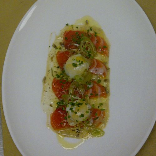 Salmon crudo with a poached quail egg and micro ce