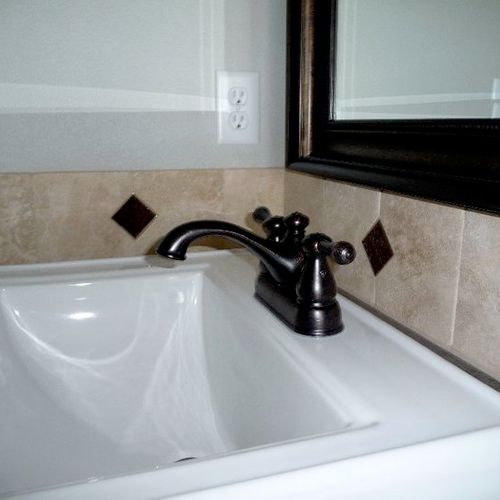 Replacing faucets and mirrors with a more contempo