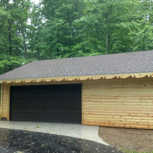 A 24' by 30' garage with log siding.