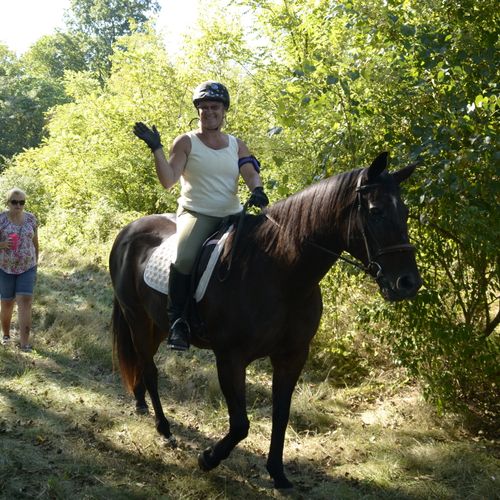 Betsy, Adult Student,enjoying a trail ride, on her