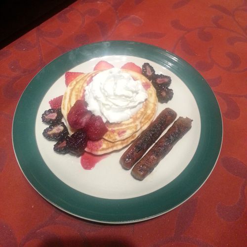 Fun pancakes with maple sausage and fruits topped 