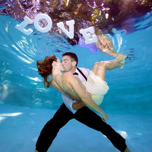 Under water engagement shoot with floating letters