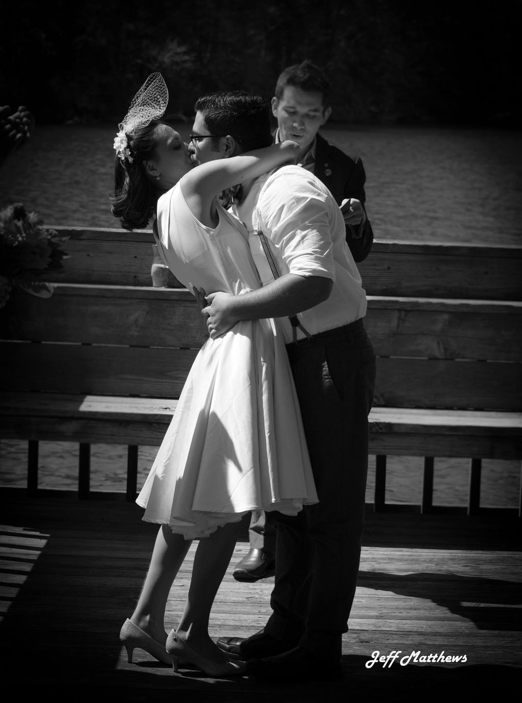 Blessing the Bride and Groom as they embrace for t