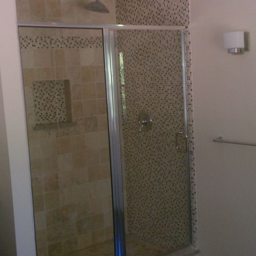 Shower with custom tile work in the same bathroom 