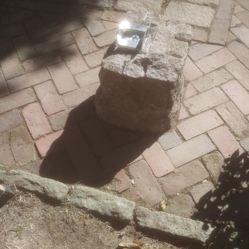 granite buried 3.5' down, cut and relay brick pati